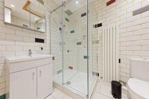a bathroom with a shower and a sink and a toilet at Ramsgate Harbour Retreat in Kent