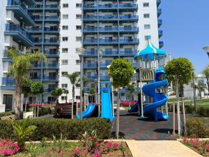 a playground in front of a apartment building at Deniz Manzaralı Rezidans Daire in Saint Yeorgios
