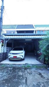 a white car is parked in a garage at Moo Deng house Near old city,Street food Changpuek Market in Chiang Mai