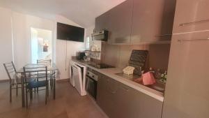 a small kitchen with a table and a counter top at Chez Aldo in Ajaccio