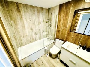 a bathroom with a toilet and a sink at Casa Luciano in Dunkerque +17 photos