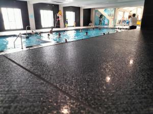 a large swimming pool with people in it at 3 Bedroom Caravan, Edi Rita, Robin Hood, Pet Friendly in Meliden