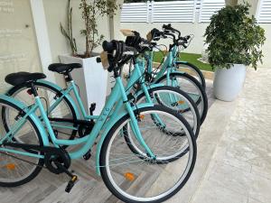 a row of blue bikes parked next to each other at Suimi's Hotel in Villasimius