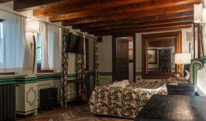 a bedroom with a bed and a fireplace and a television at Regal House Verona REGIMENTAL in Verona