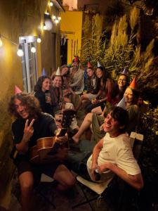 a group of people sitting in chairs with party hats at Casanaga in Almáciga
