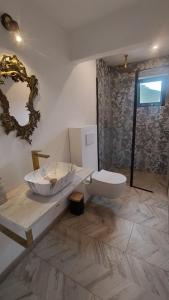 a bathroom with a sink and a toilet at Alegria rustica 2 Rustic happiness in Envendos +26 photos