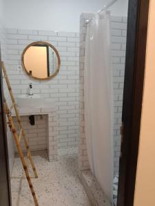 a bathroom with a sink and a mirror at Compass Homestay in Huu +5 photos