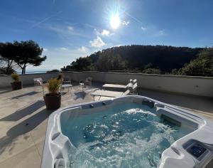 a hot tub on the roof of a house at Villa LE CIEL D EZE in Èze