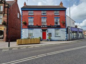 a red and blue building on the corner of a street at Room near East Midland Airport 6 in Kegworth