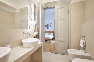 a white bathroom with a sink and a toilet at Wenceslas Square Residence in Prague