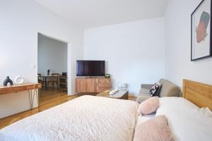 a living room with a couch and a tv at Wenceslas Square Residence in Prague