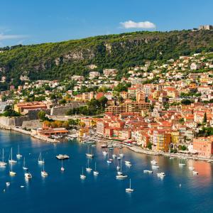 a group of boats in a harbor with a city at Olive Grove Retreat in La Trinité