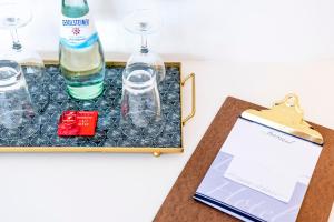 a tray with glasses and a bottle on a table at Beach Hotel in De Haan