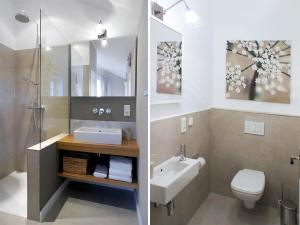 a bathroom with a sink and a toilet and a mirror at Attractive apartment in Westerstede in Westerstede +24 photos