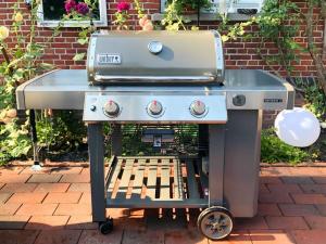 a grill sitting on a cart with a grill at Attractive apartment in Westerstede in Westerstede