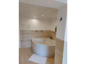 a white bath tub in a bathroom with white walls at Holiday house on Bornfeld in Leimen