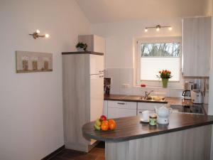 a kitchen with a counter top with fruit on it at Luxury holiday house "Schleibrise" in Hestoft