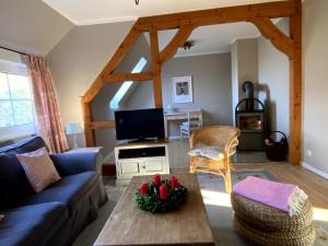 a living room with a couch and a table at Sophienhof Lieselotte in Neuenkirchen