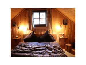 a bedroom with a bed with a large blanket at Holiday home Placzek in Schierke