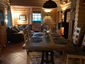 a wooden dining room with a table and a couch at Holiday home Placzek in Schierke +32 photos