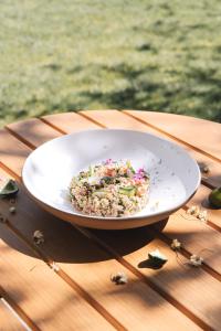 a bowl of food sitting on a wooden table at La Bastide du Mourre in Oppède