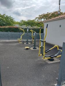 a row of gym equipment in a parking lot at Mobil-Home Location de Vacances in Talmont +7 photos