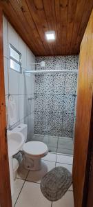 a bathroom with a toilet and a sink and a shower at Suites Casa da sua mãe in Visconde De Maua