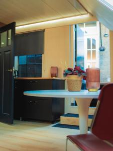 a kitchen with a table with a potted plant on it at De Smederij in Bolsward +10 photos