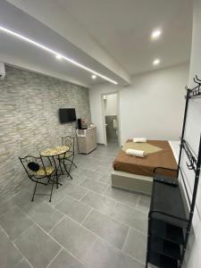 a bedroom with a bed and a table and chairs at Luna di Sicilia in Palermo +15 photos