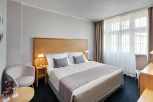 Voodi või voodid majutusasutuse Hotel Clement toas