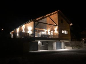 a house lit up at night with lights at le chalet de st Anne in Jausiers