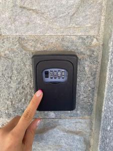 a person holding a remote control on the ground at Coccole in Villa, B&B close to outlet in Serravalle Scrivia +7 photos
