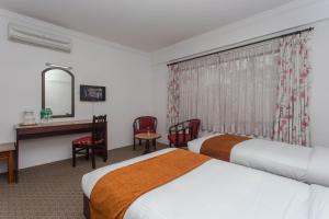 Voodi või voodid majutusasutuse Fuji Hotel toas