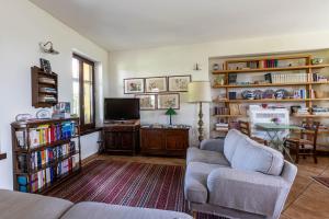 a living room with a couch and a tv at Cascina Gaggioli in Milan