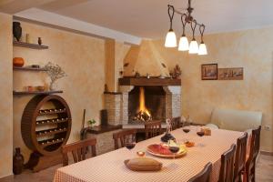 a dining room with a table and a fireplace at Villa Diora in Karojba