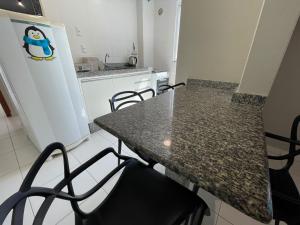 a kitchen with a table and chairs in a room at Residencial Alianza - Depto de 1 habitacion 203 in Bombas