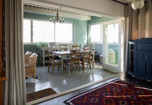 a dining room with a table and chairs in a room at De Boerderij in Strand