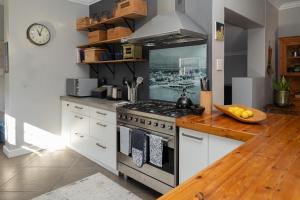 a kitchen with a stove and a counter top at De Boerderij in Strand