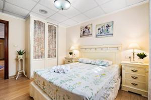 a bedroom with a bed and two night stands at Casa Starlite Sunrise in Almoradí