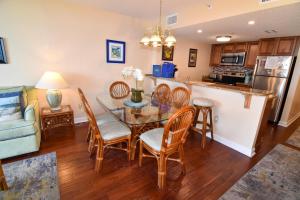 a kitchen and dining room with a table and chairs at Verandas 707 in Myrtle Beach
