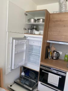 an empty refrigerator with its door open in a kitchen at Náš Sen - Apartmán in Svratouch