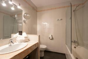 a bathroom with a sink and a toilet and a shower at Aparthotel AnyosPark Mountain & Wellness Resort in Anyós