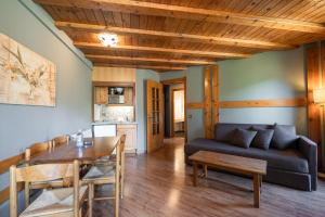 a living room with a couch and a table at Aparthotel AnyosPark Mountain & Wellness Resort in Anyós