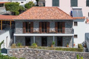 an image of a house with a tile roof at Casa de Pedra by An Island Apart in Ribeira Brava