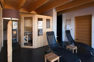 a living room with two chairs and a table at Alpenlofts in Bad Gastein