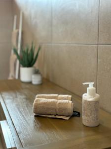 a bathroom counter with a towel and a bottle of soap at Vrede Luxury Tented Camp in Kosmos +31 photos