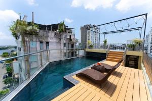 a balcony with a swimming pool on top of a building at DRAGON HUE HOTEL in Hue