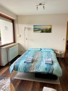 a bedroom with a large bed with towels on it at Ferienwohnung Laura in Bad Sachsa