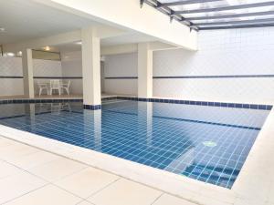 a swimming pool with blue tiles on the floor at Praia Brava Hotel in Florianópolis