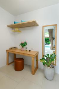 a wooden table in a room with a mirror at Villa Mimosa 1, Splendid 4 Bedroom Master Ensuite in Phuket Town